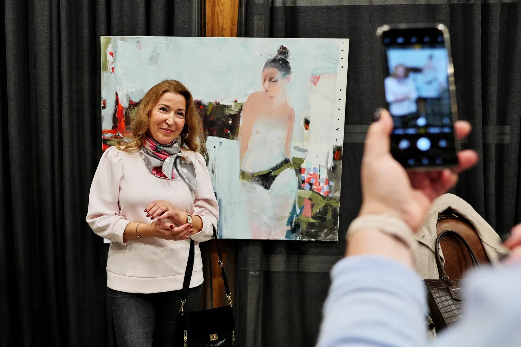 Visitor with a painting at the exhibition